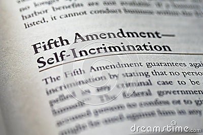 closeup of The Fifth Amendment right to not self-incrimination printed and highlighted in textbook on white page. Stock Photo