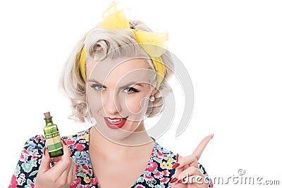 Fifties housewife with poison bottle, humorous concept, isolated Stock Photo