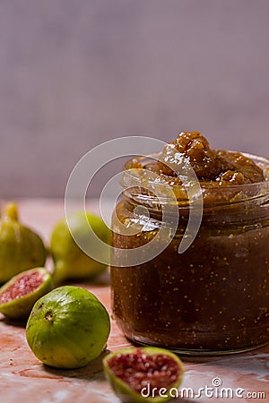 Fig Jam in Jar Surrounded by Fresh Figs Stock Photo
