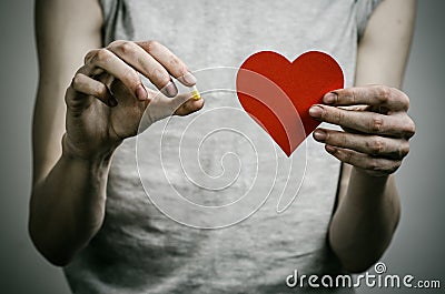 The fight against drugs and drug addiction topic: addict holding a narcotic pills on a dark background Stock Photo