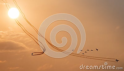 Fighter jets flying in formation at sunset Editorial Stock Photo