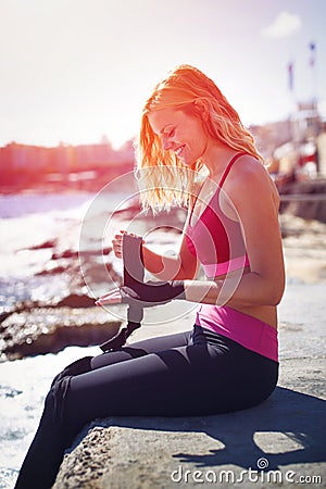 Fighter woman wrapping hands Stock Photo