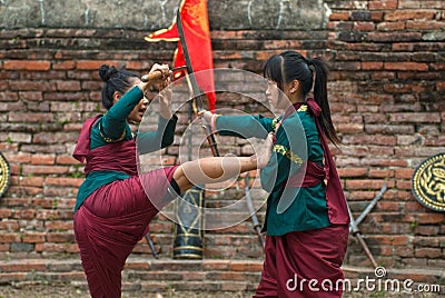 Fighters take part in an outdoor ancient Thai fencing. Editorial Stock Photo