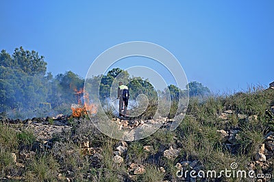 Fighting A Bush Fire With An Extinguisher Editorial Stock Photo