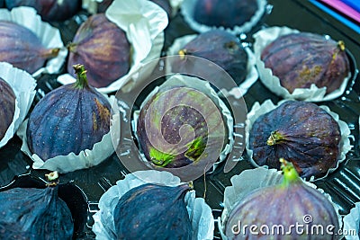 Figs in a paper containers are put up for sale on fruit market Stock Photo