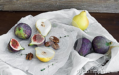 Figs, pears and pekan nuts on a white tissue Stock Photo