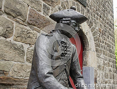 Figure of a carving Pennsoldier in bronze by Klaus Gehlen, 2007. Stock Photo