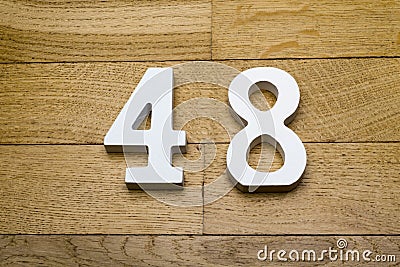 Figure forty-eight on the wooden, parquet floor. Stock Photo