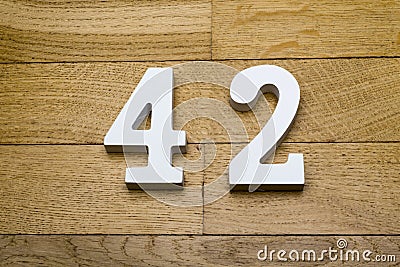 Figure forty-two on the wooden, parquet floor. Stock Photo