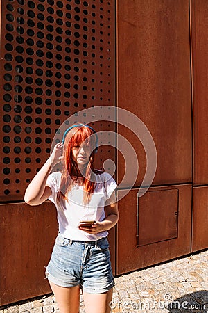 Figure of girl in full length on street with phone Stock Photo