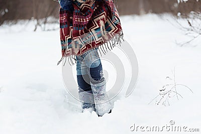 The figure of a young woman in bright ethnic scarf with purple, white and blue pattern Stock Photo