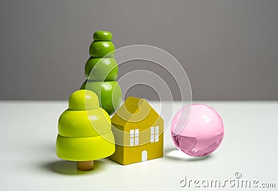 Figures of a house and a globe of planet earth. Stock Photo