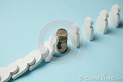 Figures of people in row with coins, domino effect. Financial and economic stability Stock Photo