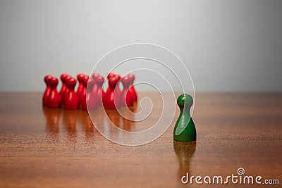 Symbolism wooden red and green figures for business exclusion racism mobbing hate religions Stock Photo