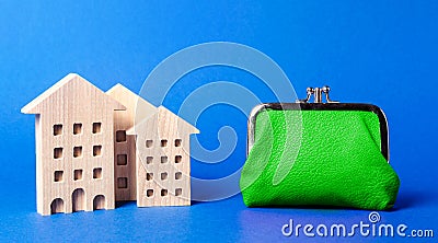 Figures of residential buildings near a large green wallet. concept of the cost of maintaining the building and utility bills. Stock Photo