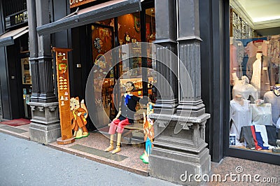 Figurine of Pinocchio, a fairytale wooden boy on a bench. Editorial Stock Photo