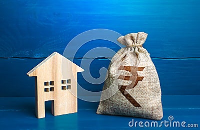 Figurine silhouette house and indian rupee money bag. Maintenance, property improvement. Taxes. Mortgage loan. Sale of housing. Stock Photo