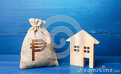 Figurine silhouette house and philippine peso money bag. Buying and selling real estate. Maintenance, property improvement. Stock Photo
