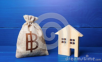 Figurine silhouette house and thai baht money bag. Maintenance, property improvement. Buying and selling real estate. Mortgage Stock Photo