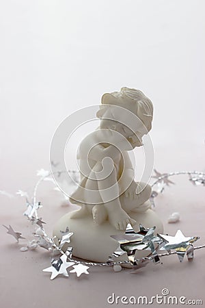 Figurine of a sleeping angel on a white background. Stock Photo