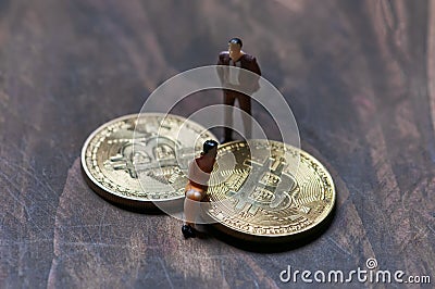 Figurines gathered around the bitcoin, an interpretation of investors Stock Photo