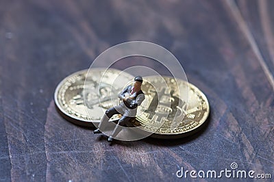 Figurines gathered around the bitcoin, an interpretation of investors Stock Photo