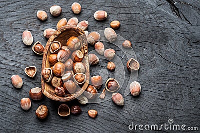 Filberts or hazelnuts in the wooden bowl on the table. Stock Photo