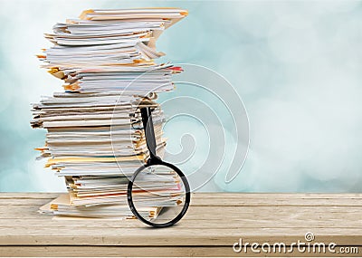 File folders with documents and magnifying glass Stock Photo