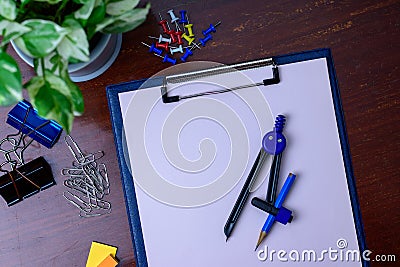 File, pencil and office supplies. Placed beside a tree on a wooden table Stock Photo