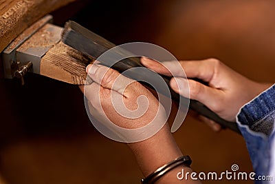 Filing out the problem. An artist creating something out of wood. Stock Photo