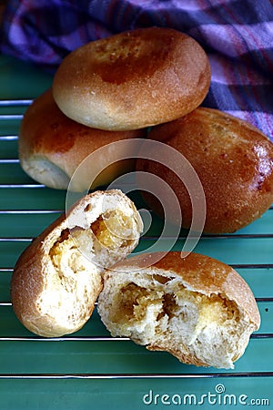 Filipino bread called Pan de Coco or bread roll filled with sweetened shredded coconut meat Stock Photo