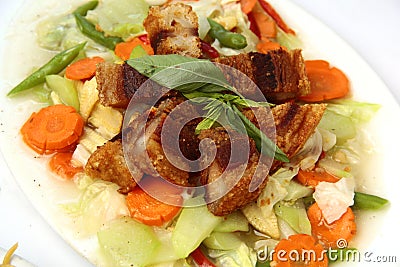 Filipino dish called Chopsuey topped with Lechon Kawali Stock Photo