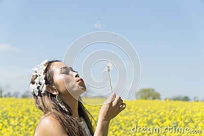 Filipino model in a rapeseed field in the springtime Stock Photo