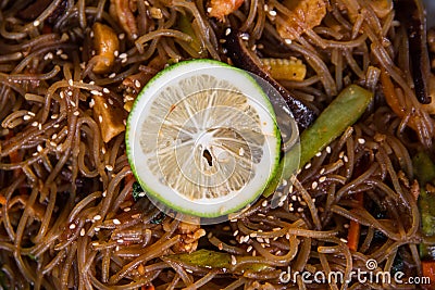 A Filipino noodle cuisine called pansit served with sliced lemon for garnish Stock Photo