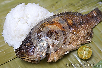 Filipino traditional dish: fried philippine tilapia fish with rice Stock Photo