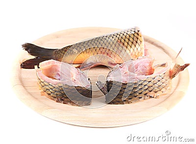 Fillets and tail raw carp on a wooden board. Stock Photo