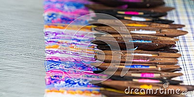 Filling carriers of the loom with woven cloth on background Stock Photo