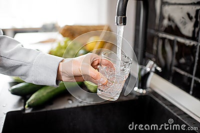 Filling drinking glass with tap water Stock Photo