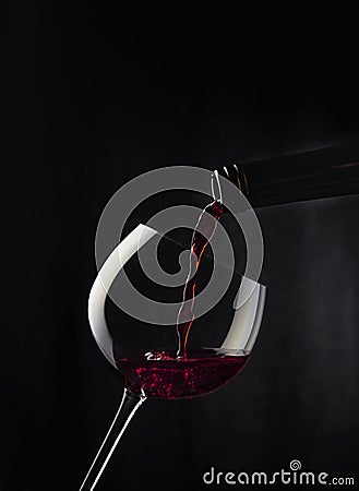 Filling glass with red wine Stock Photo