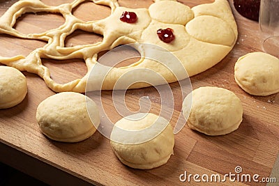 Filling homemade doughnuts made from yeast dough with marmalade Stock Photo