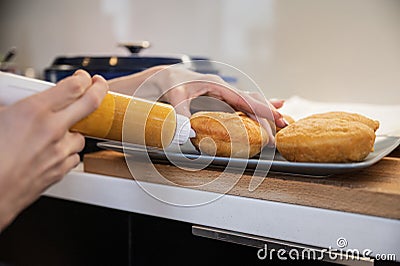 Filling homemade fried vegan doughnuts with apricot jam Stock Photo