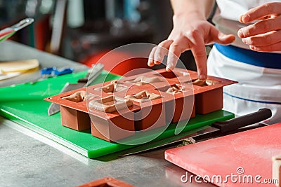 Filling silicone mold with hands Stock Photo