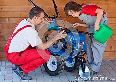 Filling up a tiller machine - small scale agriculture Stock Photo