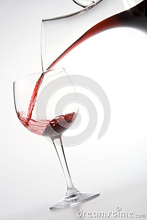 Filling wineglass from decanter Stock Photo