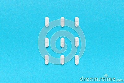 Film coated white oval tablets flat lay top view Stock Photo