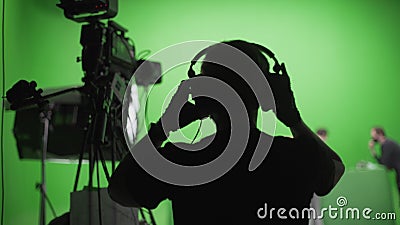 Film Crew in Green Studio Stock Photo