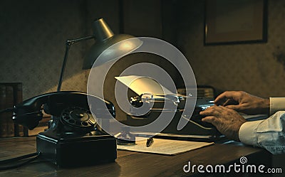 Film noir journalist working at office desk Stock Photo