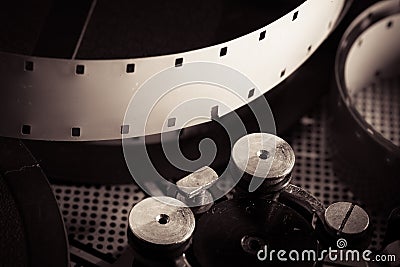 Film reel inside old-fashioned retro movie camera mechanism Stock Photo