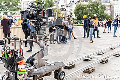 Film set production, near Notre-Dame Cathedral, artificial fog, actors playing scene for movie Editorial Stock Photo