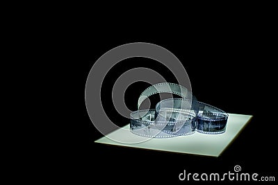 Film Strip on lightbox, total view, black background Stock Photo